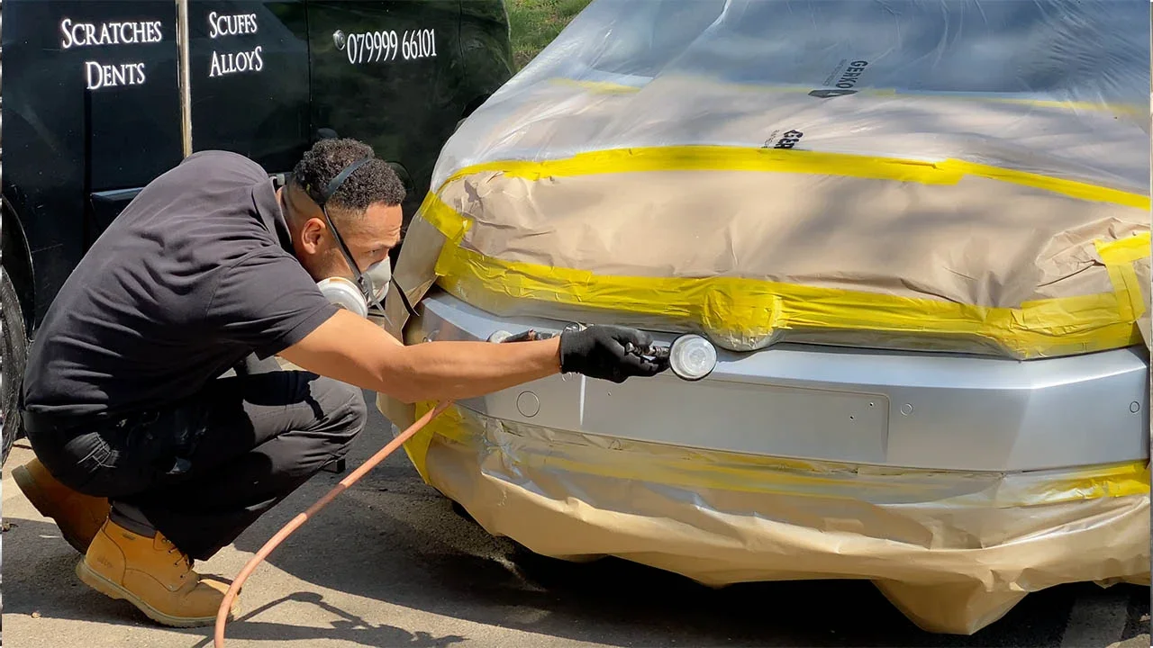 King technician professionally repairing a bumper at a customer's location