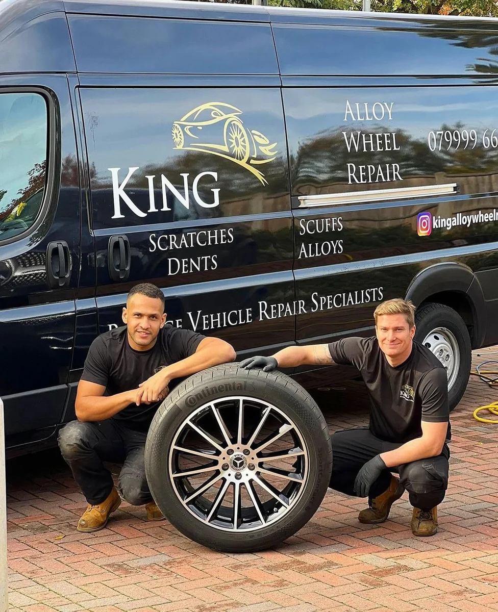 Two King repair specialists beside their branded mobile van